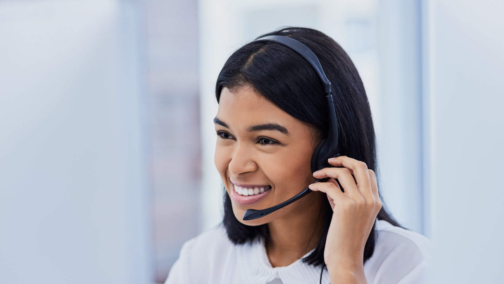 Lady call centre agent smiling and speaking on call